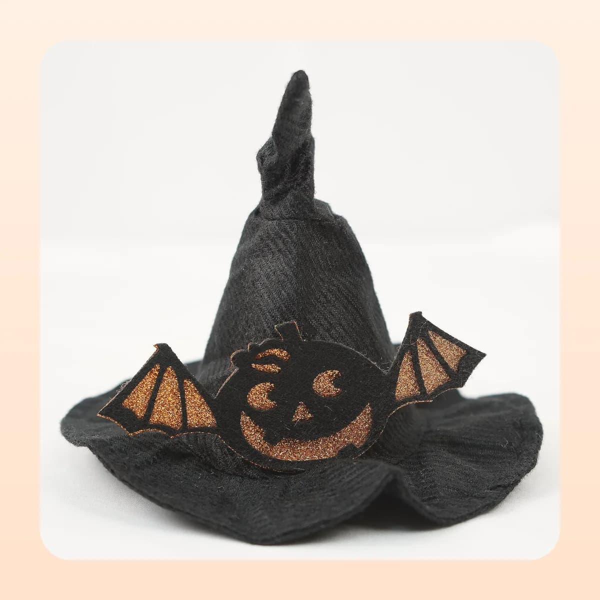 Kindral pointed witch hat with the bat-winged pumpkin appliqué
