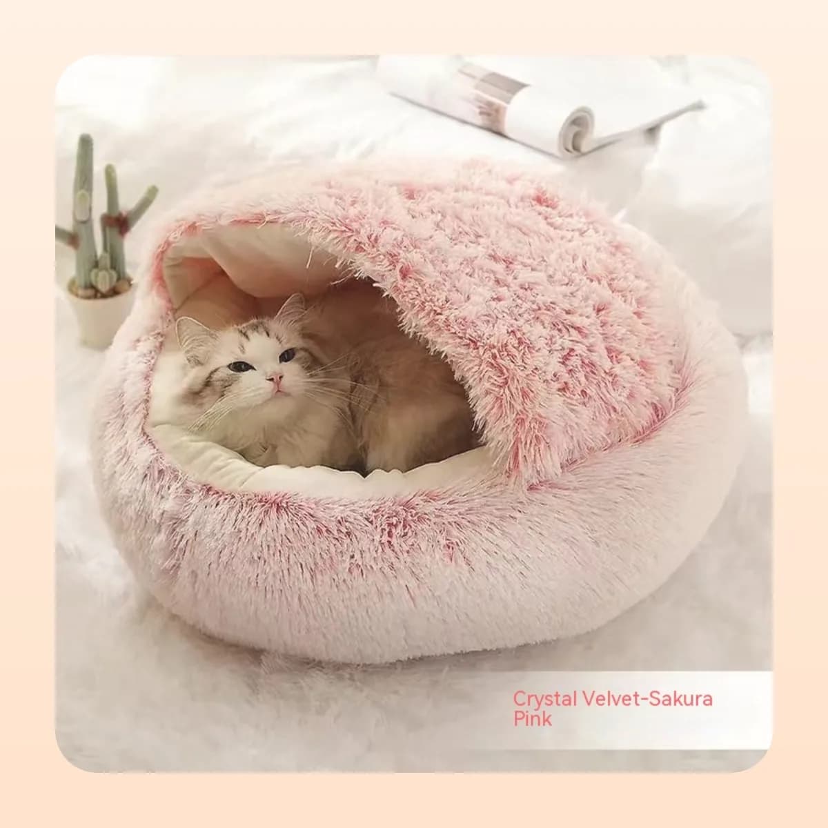 Cat curled inside the Kindral burrow bed in sakura pink crystal velvet