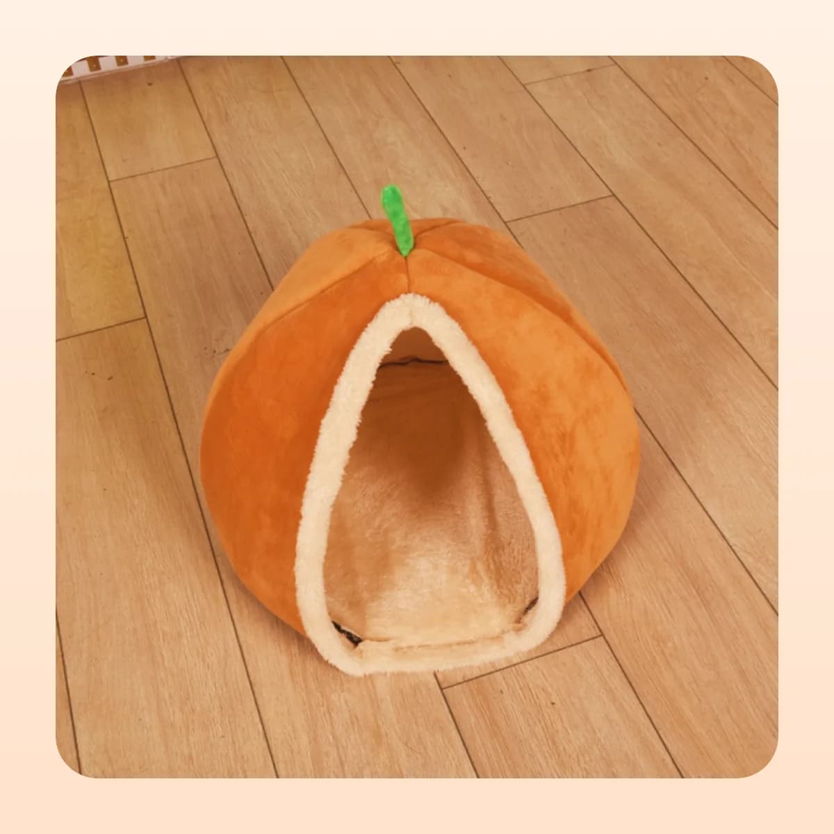 Kindral pumpkin cave bed photographed on a wooden floor