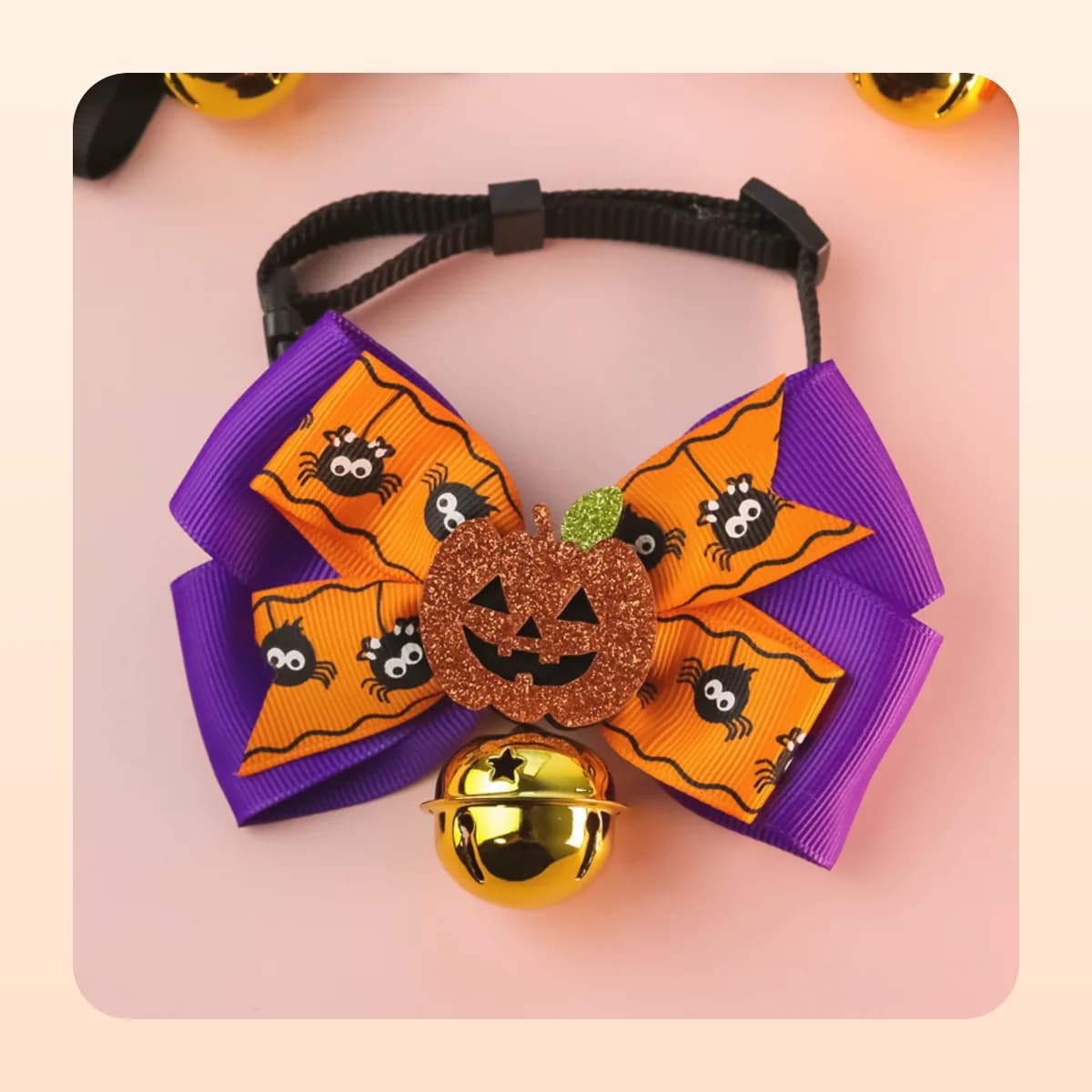 Kindral pumpkin bow tie in the spider print with a gold bell
